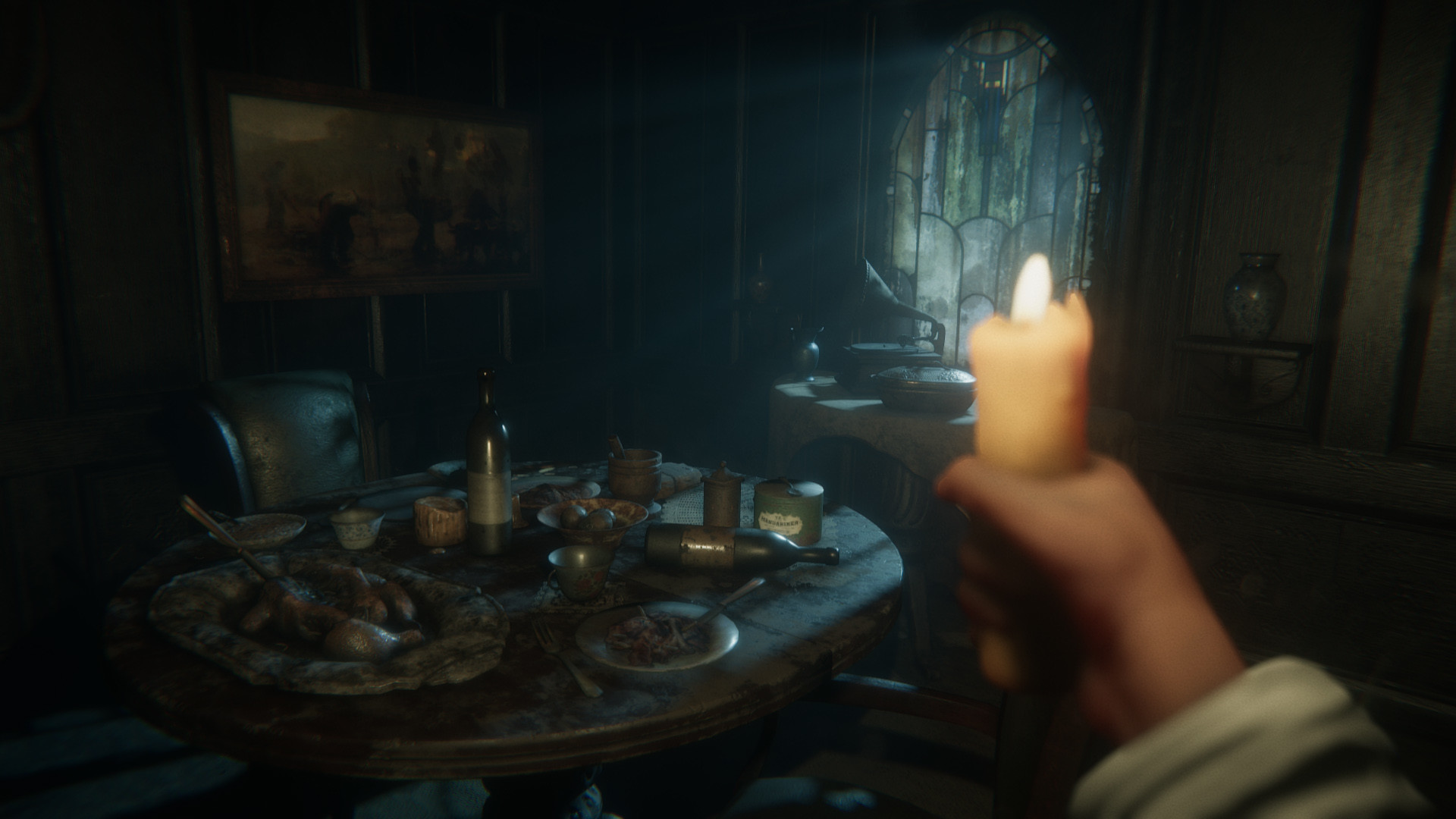 A candlelit dining table crowded with dishes inside the house
